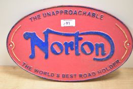 A reproduction Norton motorcycle plaque.