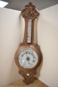 A late 19th Century oak aneroid barometer, measuring 90cm tall