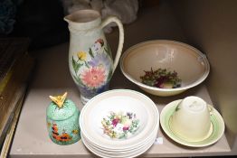 A Clarice cliff cup and saucer with floral design, a Grays pottery fruit set with fruit design to