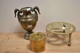 An Indian brass embossed vase, measuring 23cm tall, an Edwardian brass trivet, and a cylindrical tea