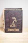 A Victorian leather bound scrap book containing 19th Century postcards and illustrations