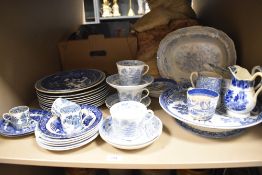 A variety of blue and white ware, including coffee cans, plates, jugs and cups and saucers.