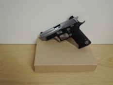 A Japanese Gas Powered 9mm Automatic Air Pistol, replica Sig Sauer, in card box. Purchaser must be