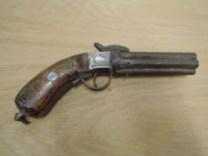 A Six Barrel Percussion Pepperbox Pistol having wood & metal decorated grip, decorated side