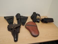 A collection of mixed vintage leather Holsters, 6 in total, various, one has belt and ammunition