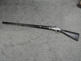 A Musket converted from a Flintlock to a Percussion, with ramrod, split in stock, barrel length