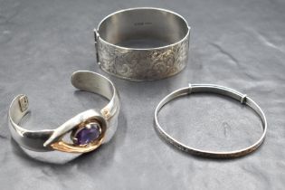 Three silver bangles including Mexican cuff, Christening style and hinged bracelet with engraved