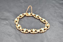 A Victorian 15ct gold bracelet having open links with turquoise and seed pearl decoration and