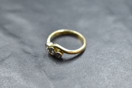 A diamond trilogy ring, approx 0.225ct total in collared mounts on an 18ct gold loop, size L &