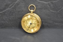 A small 18ct gold top wound pocket watch having Roman numeral dial to decorative gold face in an