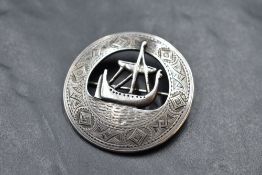 An Iona silver brooch of Celtic design having Viking ship detail within an engraved border and