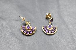 A pair of 9ct gold earrings having small collared teardrop amethyst studs with amethyst set fan