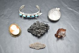 A small selection of vintage jewellery including black mourning brooch, silver locket having