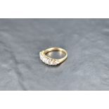 A five stone graduated diamond ring, total approx 1ct, having diamond chip spacers (3 missing) in