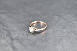 A diamond solitaire ring, approx 0.25ct in an illusionary mount on a yellow metal loop, no marks,