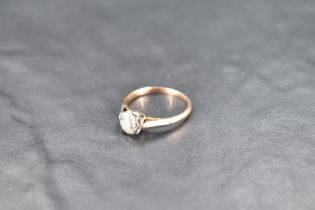 A diamond solitaire ring, approx 0.25ct in an illusionary mount on a yellow metal loop, no marks,