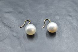 A pair of baroque pearl earrings on 18ct gold loop drops