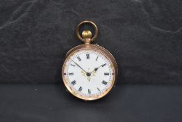 A small 9ct rose gold top wound pocket watch having Roman numeral dial to decorative enamel face