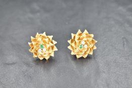 A pair of 18ct gold earrings having pole and loop fittings and modelled as multi petal flowers
