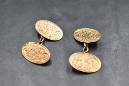 A pair of 9ct rose gold cuff links having oval panels with engraved scroll and floral decoration and