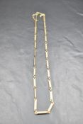 A 9ct gold bar link chain with safety chain, maker NK, approx 19' & 11.1g