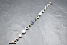 A white metal bracelet, presumed silver having blue topaz, agate, lapis lazuli and split pearl