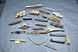 A selection of gold, yellow and white metal bar brooches, various designs, one inset with seed