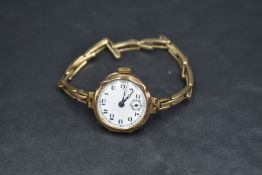 A lady's vintage 9ct rose gold wrist watch having Arabic numeral dial with subsidiary seconds to