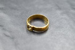 A 22ct gold wedding band having an added paste stone, size L & approx 3g