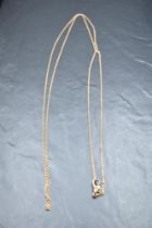 A rose gold muff chain bearing plaque marked 9ct, approx 54' & 18.7g