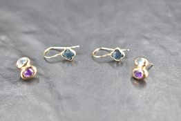 A pair of 9ct gold stud earrings having blue topaz and amethyst decoration and a pair of 9ct loop
