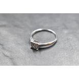 A four stone princess cut diamond ring, total approx 0.37ct in a four claw collared basket mount