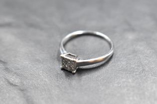 A four stone princess cut diamond ring, total approx 0.37ct in a four claw collared basket mount