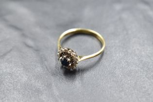 A sapphire and diamond chip open cluster in a basket mount on an 18ct gold loop, size S & 3.2g