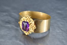 A Victorian yellow metal dual purpose amethyst bangle, the large amethyst in the form of a