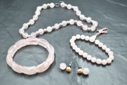 A matched set of rose quartz jewellery including earrings, necklace and two bracelets