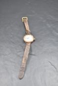 A lady's vintage 9ct rose gold wrist watch having Roman numeral dial to decorative face in plain