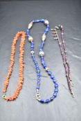 Three strings of beads including branch coral, lapis lazuli and rough cut amethyst