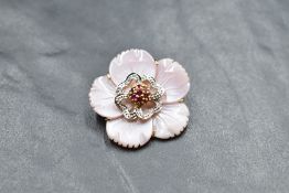 A carved pink shell brooch/pendant in the form of a flower head with diamond and ruby chip