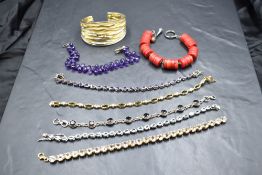 Seven bracelets and an enamelled bangle, all stamped 925, including amethyst, diamante etc