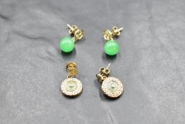 A pair of 9ct gold earrings having Chinese style studs with circular drops having jade style stone