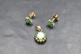 A pair of diamond and emerald style stone daisy cluster stud earrings with 9ct gold fittings and