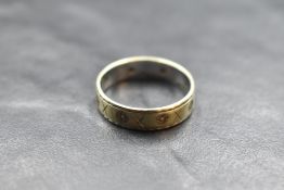 A yellow metal wedding band stamped 9ct having small diamond chip inserts, size Q & approx 3.6g