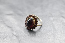 A garnet cluster ring on a white metal loop, no marks, size P & approx 4g