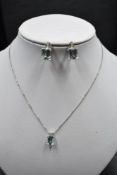 An 18ct white gold necklace by Kojis, having emerald cut aquamarine and diamond pendant with
