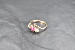 A ruby and diamond trio ring having central ruby, approx 0.5ct, two diamonds each approx 0.25ct in