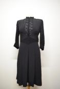 A 1940s dark navy crepe day dress, having 3/4 lace sleeves with crepe band and buttons to cuffs,