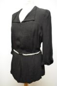 A 1940s crepe blouse having belted waist, 3/4 sleeves and button back fastening, larger size.