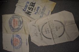 Four vintage feed and flour advertising sacks.