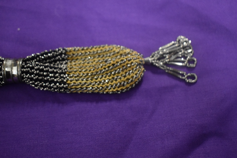 A 19th century misers purse, having steel bands and silver tone beading throughout. - Image 3 of 3